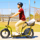 The Razor EcoSmart Cargo with a single passenger and cargo basket on the back.